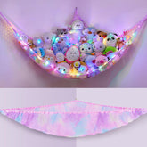 Unicorn Castle hammock with LED light brightens kids' room while storing plush toys.
