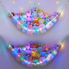 Unicorn Castle stuffed animals net hammock for tidy toy storage in kids' room.