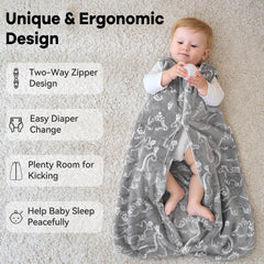 Unnivoll fleece sleep sack gray dinosaur, toddler wearing it, roomy yet snug for active movement.