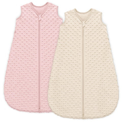 Unnivoll sleep sack with plush dots in apricot-pink provides cozy security for baby during bedtime
