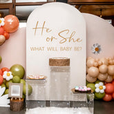 Unonede He Or She gender reveal wall decal backdrop for a photo-ready balloon arch moment.