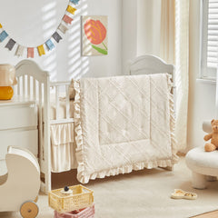 UOZZI Bedding Tufted Ruffle Crib Comforter close-up shows plush microfiber texture for cozy sleep.