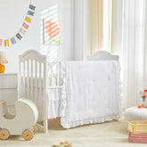 UOZZI BEDDING mini crib comforter with ruffle creates cozy naps for baby