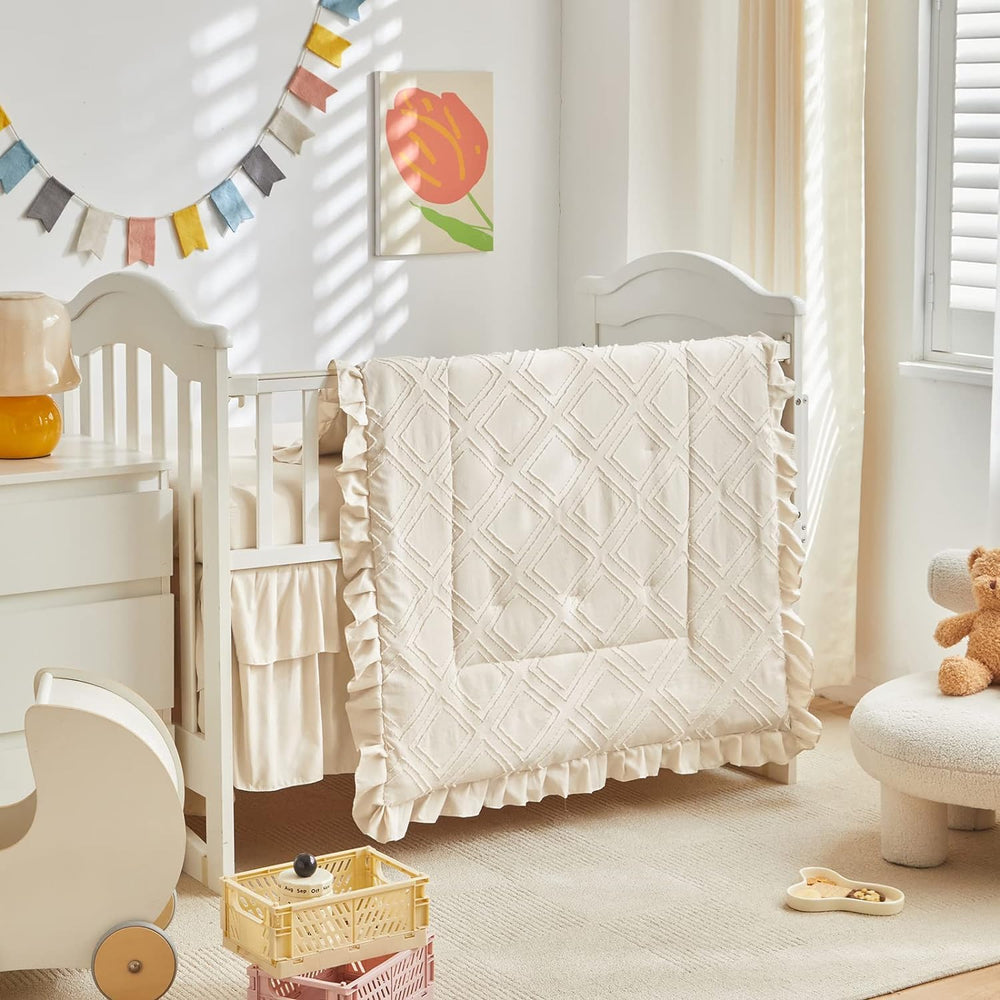 UOZZI BEDDING mini crib comforter with tufted detail for cozy sleep.