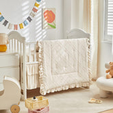 UOZZI BEDDING mini crib comforter with tufted detail for cozy sleep.