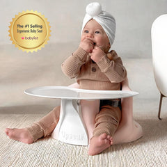 Upseat baby seat in use demonstrates transition from floor to booster seating.