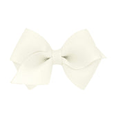 Wee Ones antique white bow closeup on WeeStay clip for secure all-day wear.