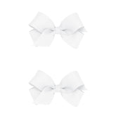 Wee Ones mini white bows on a no-slip clip showing secure hold for active kids