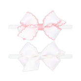 Wee Ones two mini Moonstitch bows on a skinny nylon band in light pink for versatile daily wear.