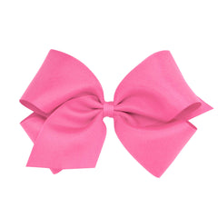 Wee Ones hot pink bow close-up on WeeStay clip for secure all-day wear.