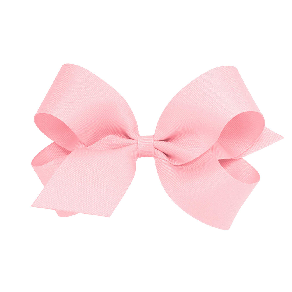 Wee Ones light pink classic wrap bow on WeeStay clip for all-day wear.