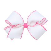Wee Ones Moonstitch edge bow closeup shows durable grosgrain with white-pink trim