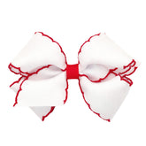 Wee Ones Moonstitch edge bow closeup on WeeStay clip showing secure grip