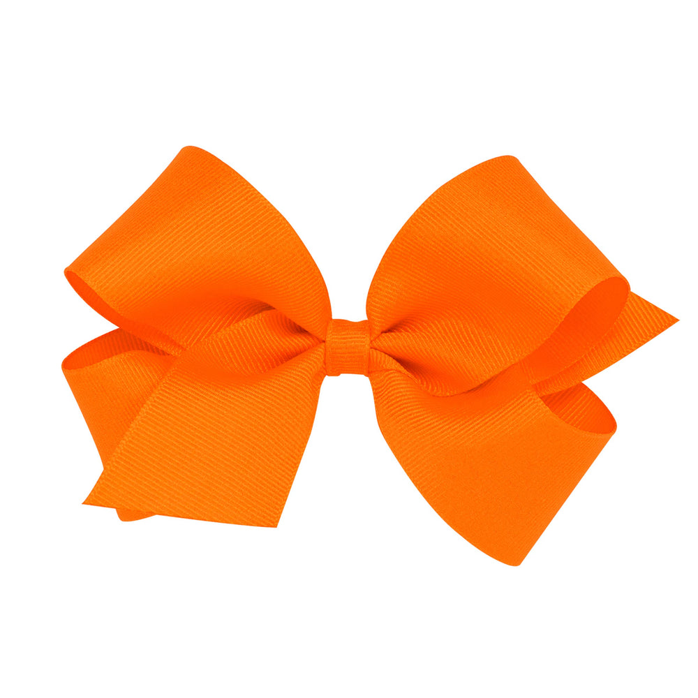 Wee Ones orange grosgrain bow close-up highlighting vibrant color and handmade detail