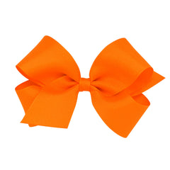 Wee Ones orange grosgrain bow close-up highlighting vibrant color and handmade detail