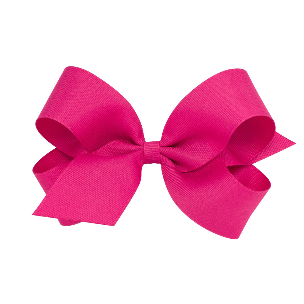 Wee Ones shocking pink bow close-up on WeeStay clip emphasizes secure all-day hold.