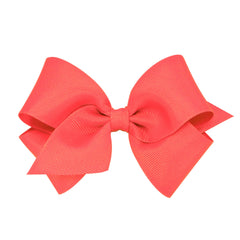 Wee Ones Watermelon bow closeup on WeeStay clip for secure all-day wear and chic color.