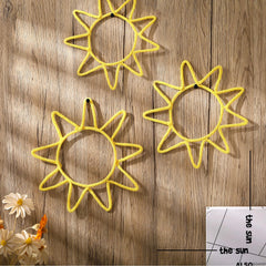 Wesiti gold knitted sun wall art creates a playful boho vibe in a kid's room.