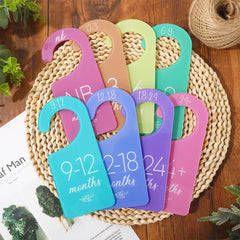 Whaline baby closet divider hanging on a standard rod in nursery.