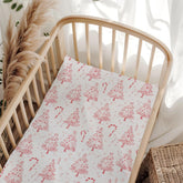 Wicbfdfv pink Christmas pine crib sheet folded for easy storage and quick setup