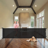 WOMHOM 100-inch extra-wide gate rolled up to save space in a living area.