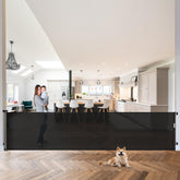 WOMHOM MomGate 120-inch retractable gate covering a wide doorway for pets and kids
