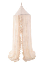 Wonder Space bed canopy in beige lace with pom poms over a crib creates a cozy sleep nook.