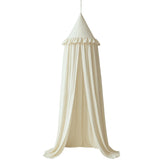 Wonder Space ivory canopy with frills draped over crib for dreamy decor