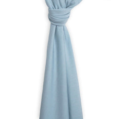 Woolino baby swaddle blanket blue on infant demonstrates secure wrap and comfort