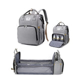 X W EI UNION diaper backpack with changing station used outdoors for easy diaper changes.