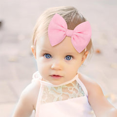 YanJie knotted bows beige headband pairs with neutral looks.
