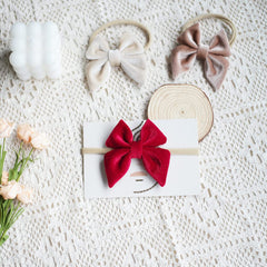 YanJie velvet bow headband in khaki showing stretchy band for growing child
