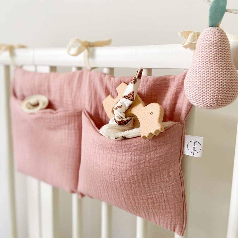 YeeMan cotton baby bedside hanging storage bag pink keeps diapers within reach.