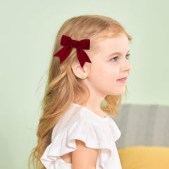Yhlen velvet bow on toddler hairstyle showing gentle comfortable grip.
