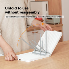 YOTIME foldable drying rack holds bottles and nipples for easy air drying.
