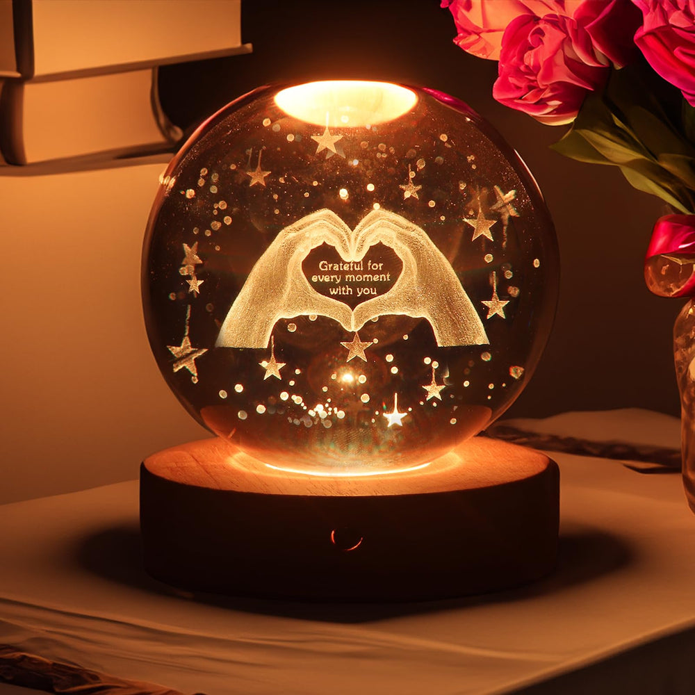 Youglatt 3D crystal ball night light on table adds cozy ambient lighting.