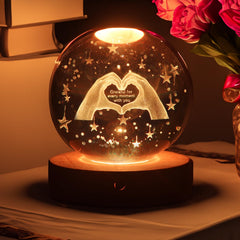 Youglatt 3D crystal ball night light on table adds cozy ambient lighting.