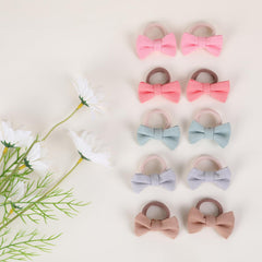 YWAOAIJD 2 inch linen bows worn by a toddler demonstrating cute, secure styling.