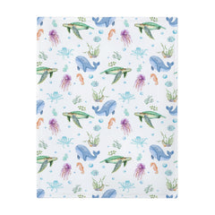 ZoUbqchY sea life baby blanket on crib scene with soft colors