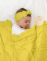 ZURLEFY Yellow swaddle hat paired with blanket for warm newborn styling.