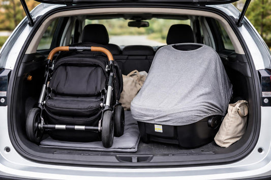 Compact stroller and car seat cover in a hatchback trunk