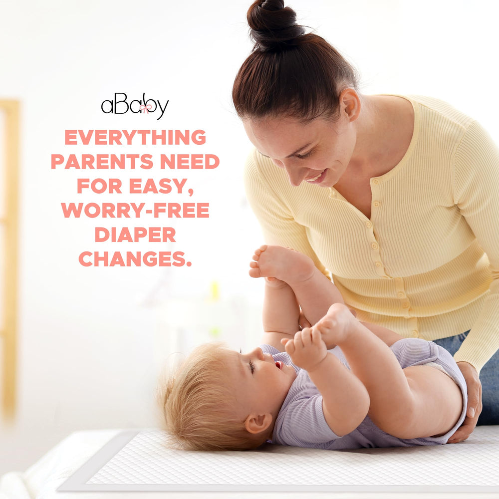 ABABY REFRESH disposable changing pads in use on table for quick, hygienic diaper changes.
