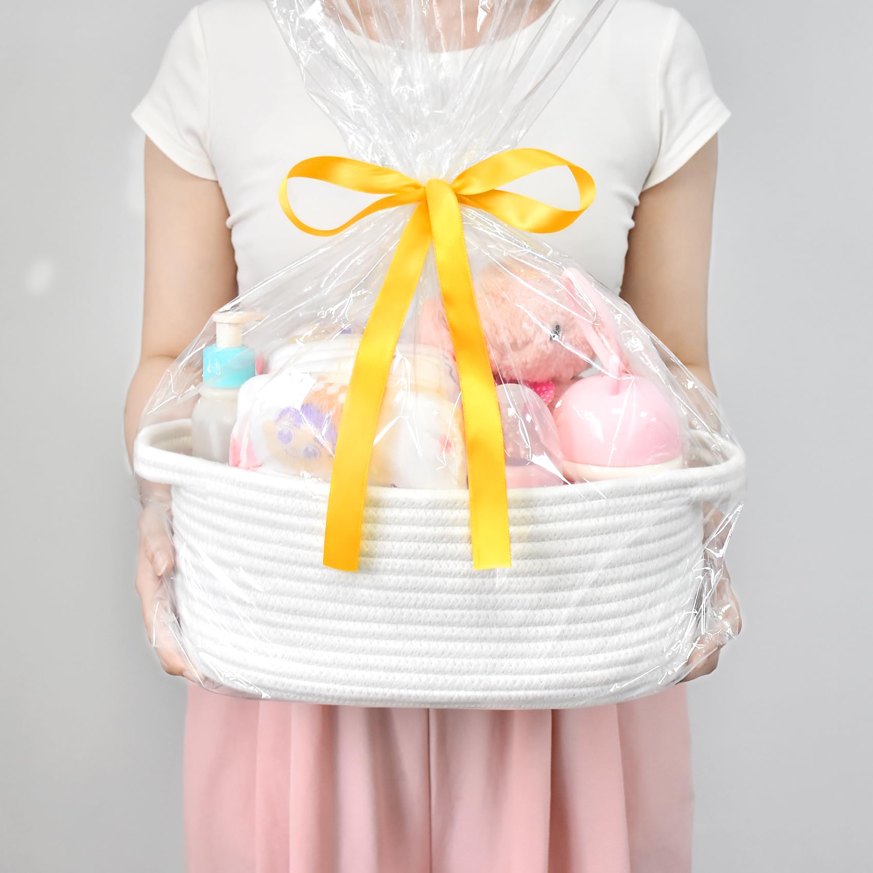ABenkle cotton rope basket shown as cozy toy organizer in a living room.