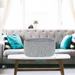 ABenkle small oval rope basket interior view organized for keys and remotes.