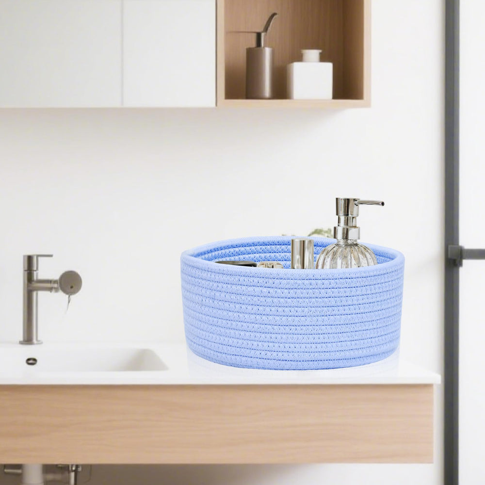 ABenkle small round basket on bathroom vanity holds cotton rounds and remotes