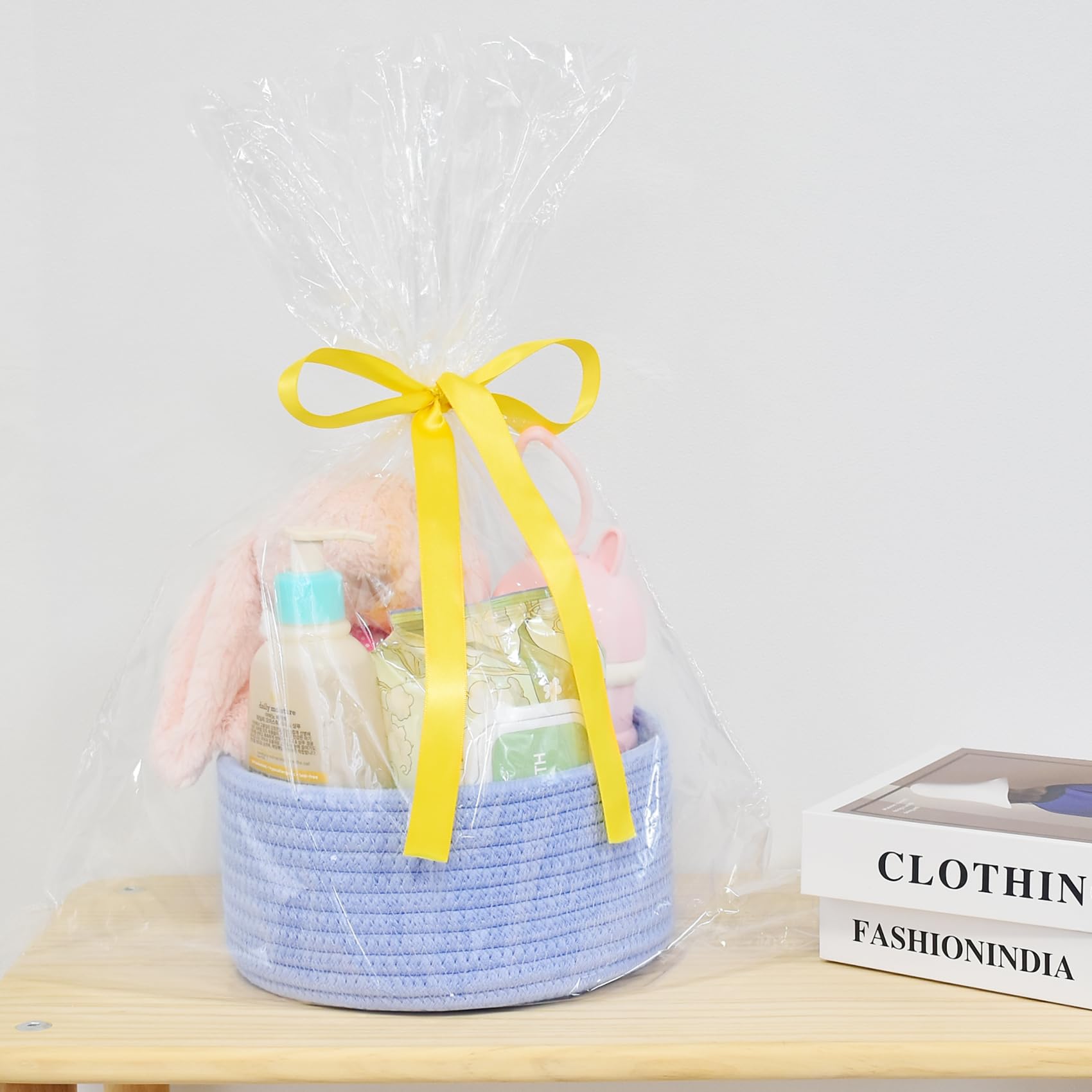 ABenkle small round basket on living room shelf for gadgets and remotes