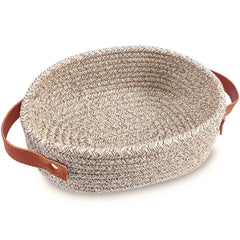 ABenkle small woven basket in oval shape for tidy bedside essentials.