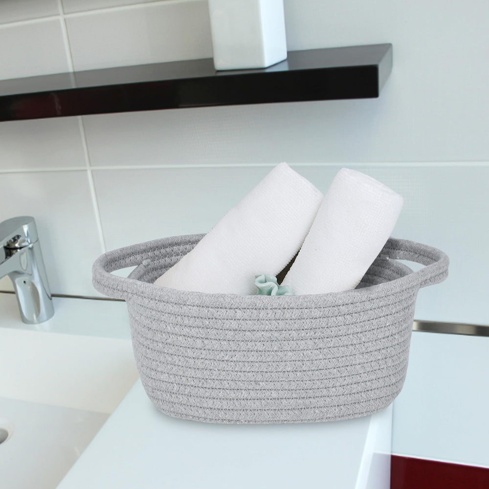 ABenkle storage basket on a bedside table shows easy grab-and-go bathroom storage.