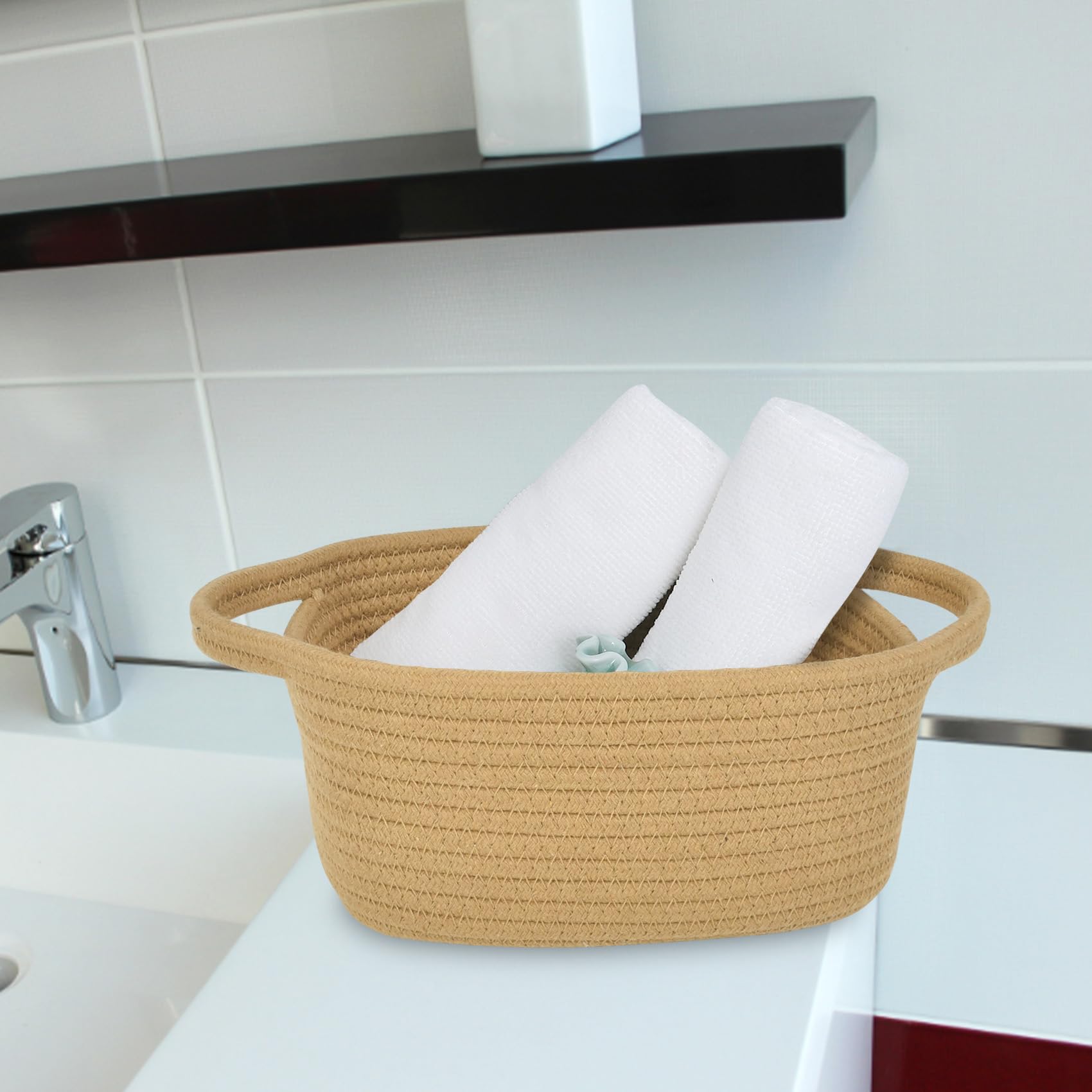 ABenkle white decorative basket with handles enhances home decor.