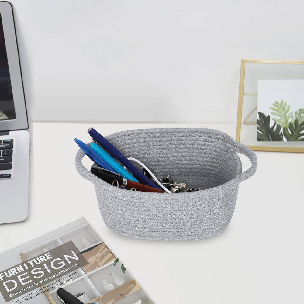 ABenkle white decorative basket with handles blends with decor while keeping essentials accessible.